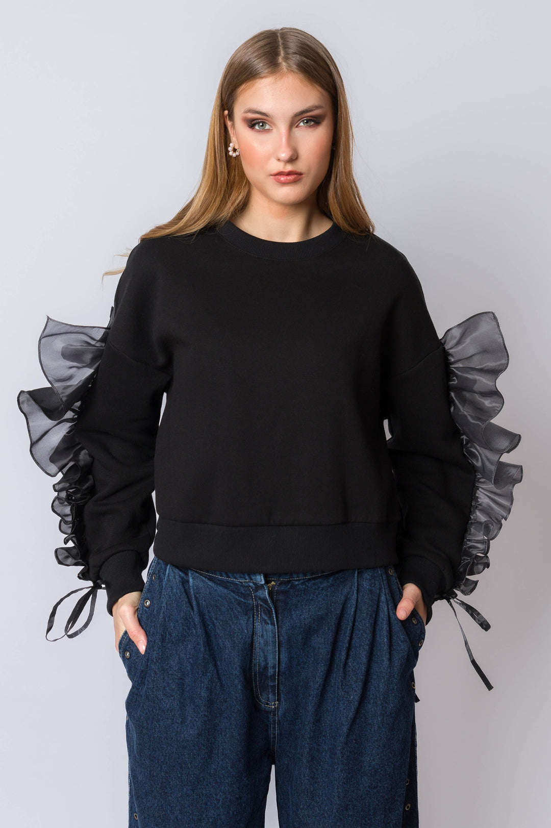 Sweatshirt with flowy ruffle sleeve detail.