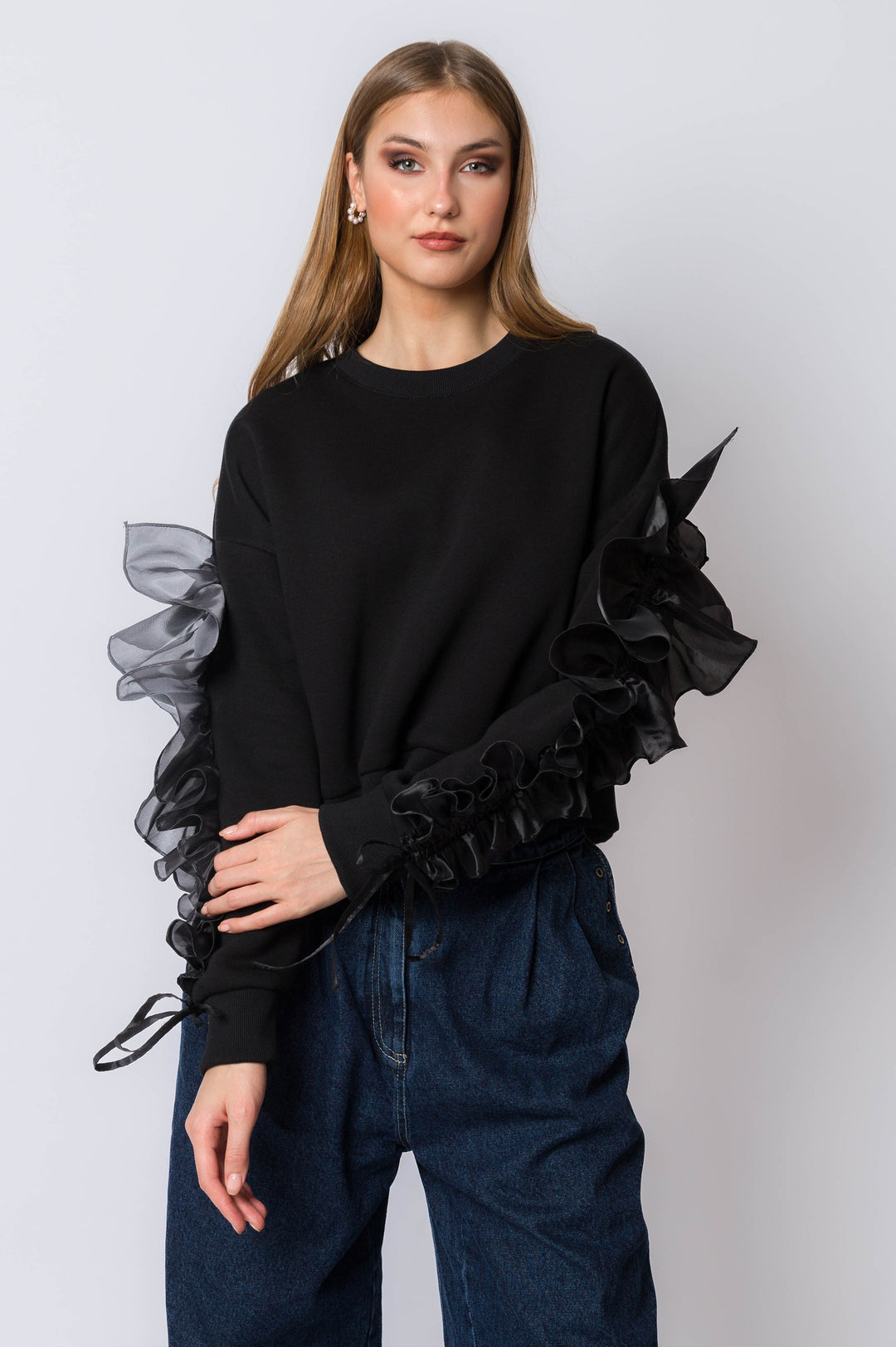 Sweatshirt with flowy ruffle sleeve detail.