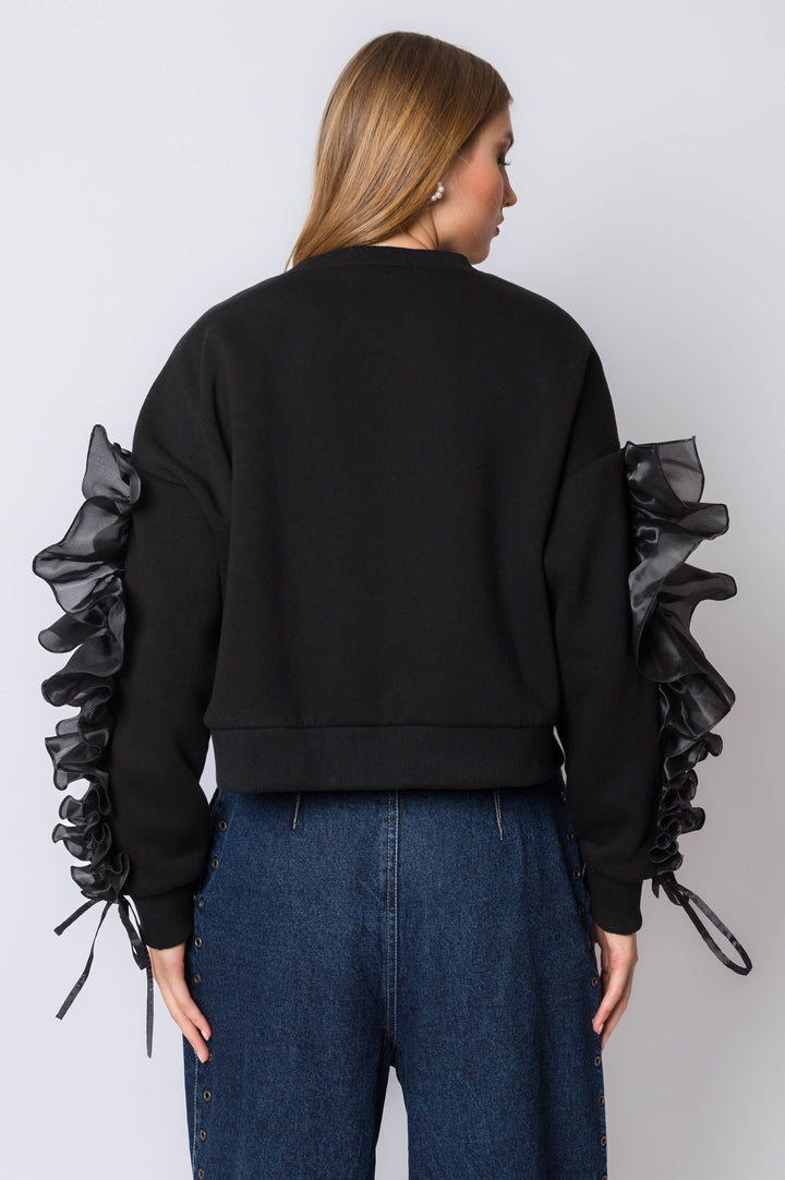 Sweatshirt with flowy ruffle sleeve detail.